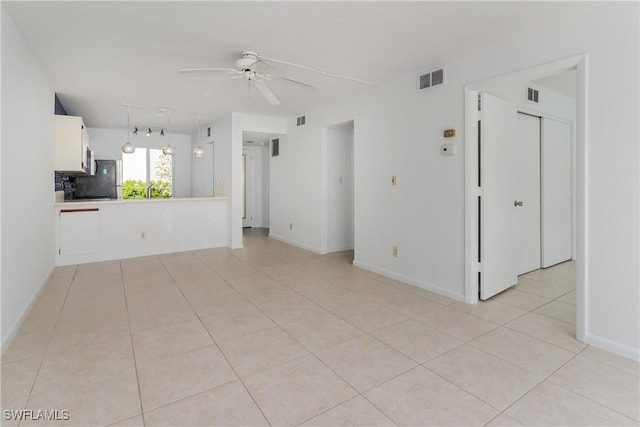 unfurnished living room with ceiling fan and light tile patterned flooring