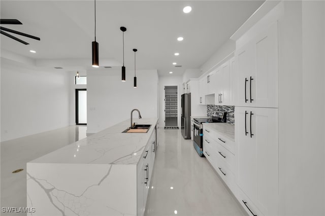 2125 Trafalgar Pkwy, Cape Coral, FL 33991 - kitchen featuring appliances with stainless steel finishes, recessed lighting, a sink, white cabinetry, and a center island with sink