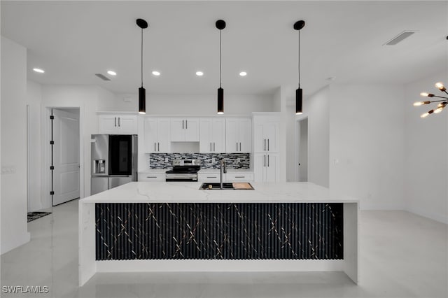 2125 Trafalgar Pkwy, Cape Coral, FL 33991 - kitchen with appliances with stainless steel finishes, a sink, white cabinetry, a large island, and light stone countertops