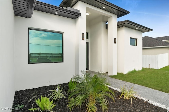 2125 Trafalgar Pkwy, Cape Coral, FL 33991 - entrance to property with stucco siding and a lawn