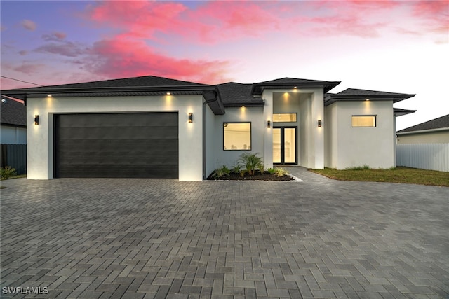 2125 Trafalgar Pkwy, Cape Coral, FL 33991 - view of front of home featuring decorative driveway, an attached garage, and stucco siding
