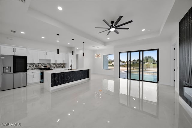 2125 Trafalgar Pkwy, Cape Coral, FL 33991 - unfurnished living room featuring a raised ceiling, recessed lighting, a ceiling fan, a chandelier, and a sink