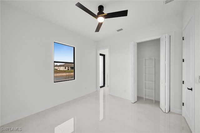 2125 Trafalgar Pkwy, Cape Coral, FL 33991 - unfurnished bedroom with a ceiling fan and a closet