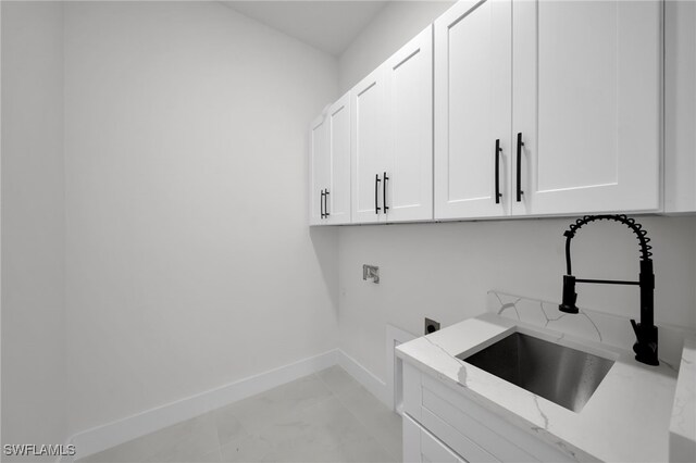 2125 Trafalgar Pkwy, Cape Coral, FL 33991 - laundry area featuring hookup for a washing machine, cabinet space, hookup for an electric dryer, and baseboards
