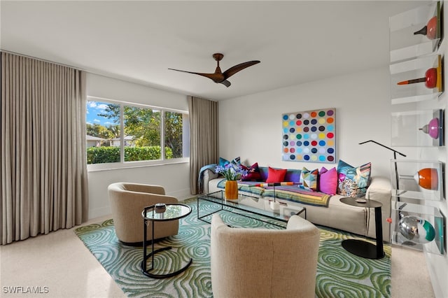 carpeted living area with ceiling fan