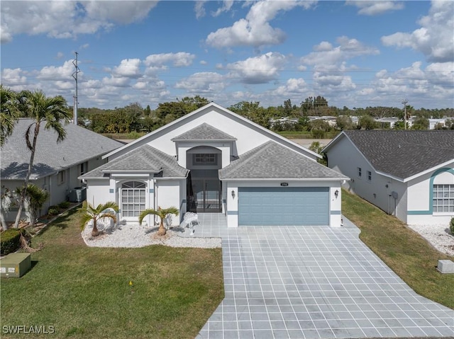 view of front of home with a front yard and a garage