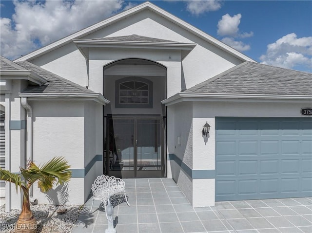 view of exterior entry with a garage