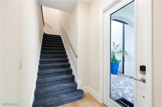 stairway with hardwood / wood-style flooring