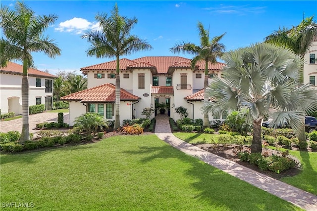 mediterranean / spanish-style home featuring a front yard