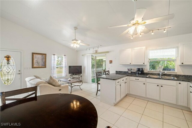 kitchen with white cabinetry, sink, kitchen peninsula, and ceiling fan