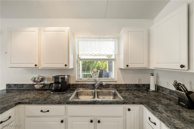 kitchen with white cabinetry and sink