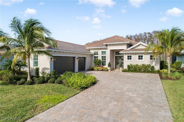 view of front facade with a garage and a front lawn