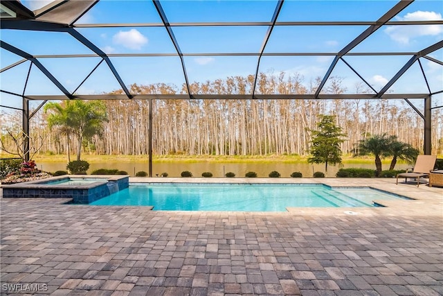 view of pool featuring an in ground hot tub, glass enclosure, and a patio area