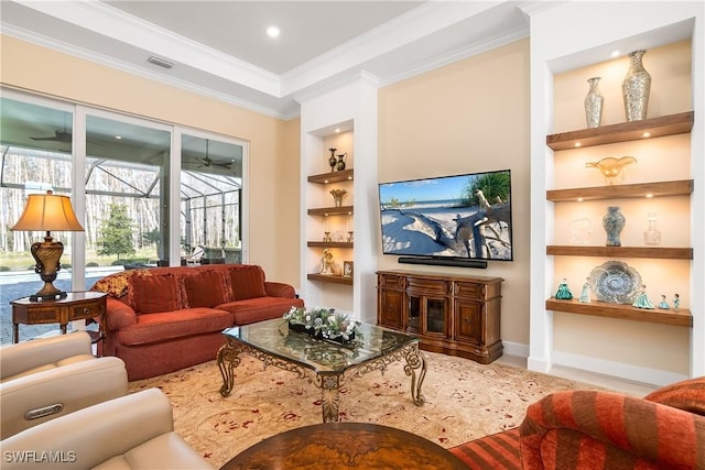 living room with ornamental molding, built in features, and ceiling fan