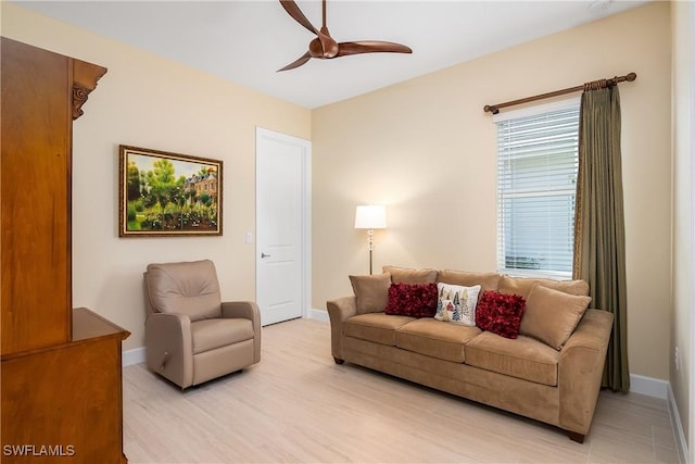 living room featuring ceiling fan and light hardwood / wood-style flooring