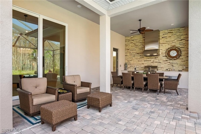 view of patio / terrace featuring a lanai, outdoor lounge area, and ceiling fan