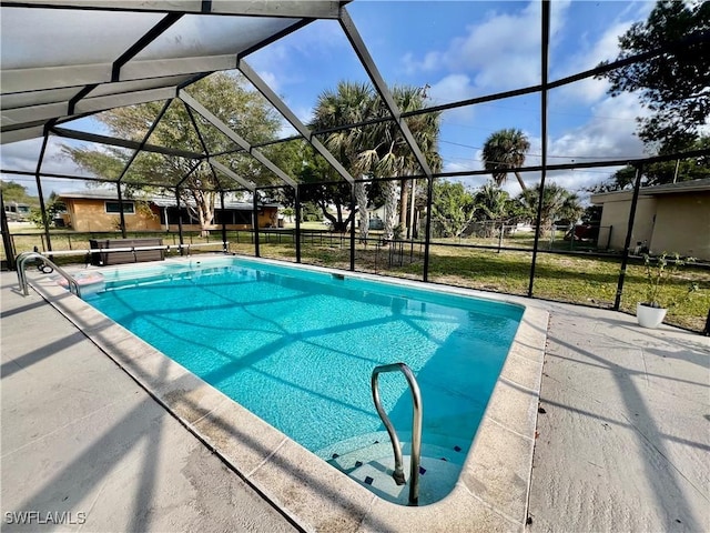 view of pool featuring a patio area and glass enclosure