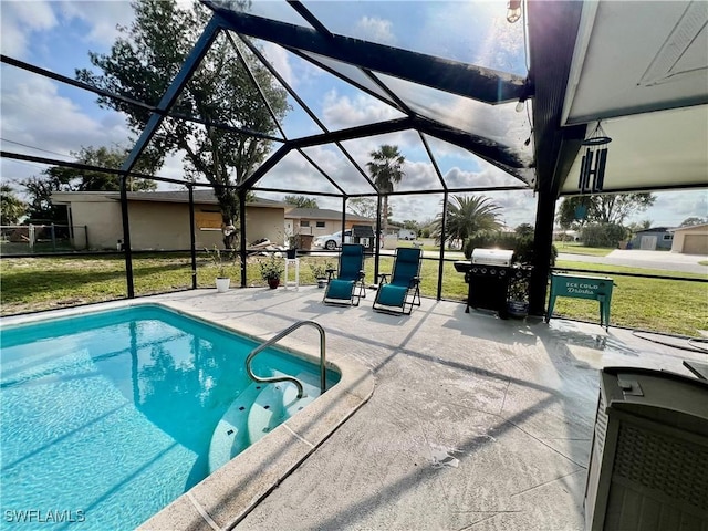 view of pool with a patio, glass enclosure, and a lawn