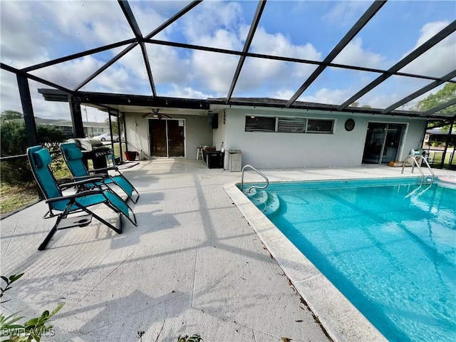 view of pool with a lanai, ceiling fan, and a patio area