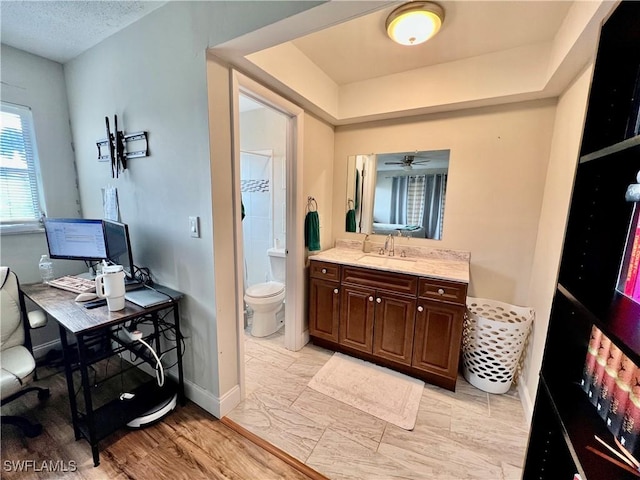 bathroom featuring vanity, a textured ceiling, and toilet