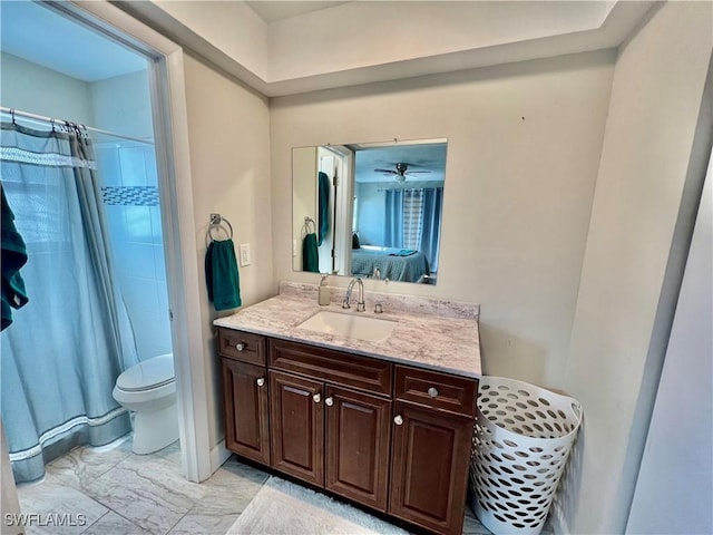 bathroom featuring walk in shower, vanity, and toilet