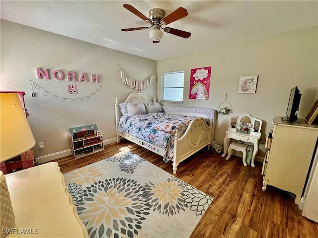 bedroom featuring dark hardwood / wood-style flooring and ceiling fan