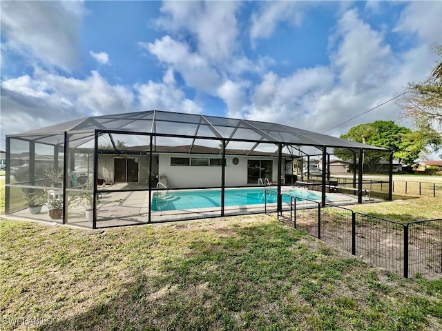 view of pool featuring a yard, a patio, and glass enclosure