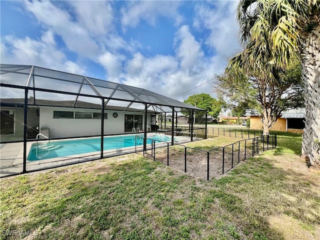 view of swimming pool with a yard and a lanai