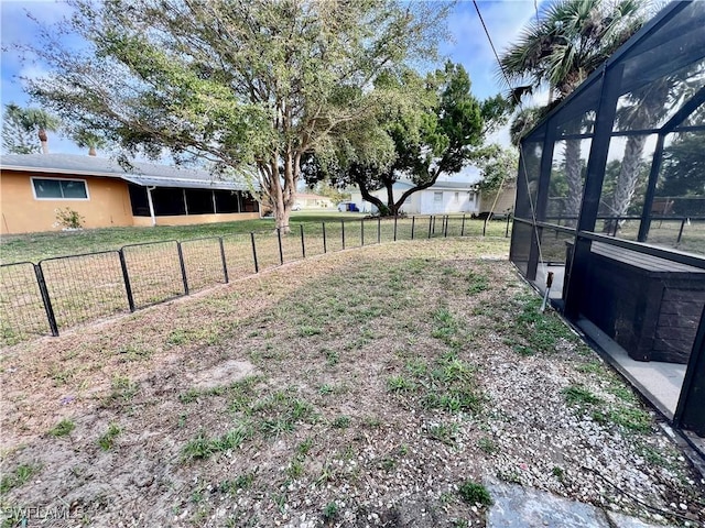 view of yard with glass enclosure