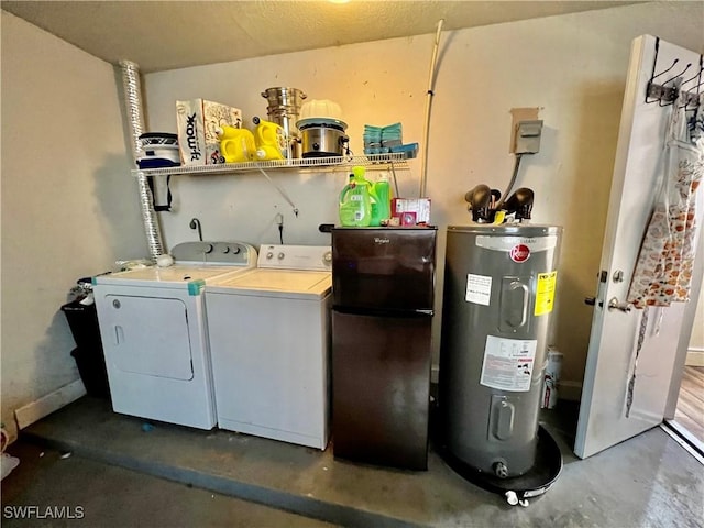 clothes washing area with washer and dryer and electric water heater