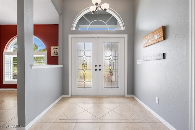 foyer featuring light tile patterned floors and french doors