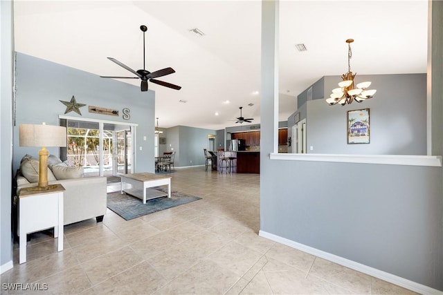 living room featuring light tile patterned floors, ceiling fan with notable chandelier, and vaulted ceiling