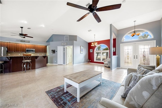 tiled living room featuring french doors, high vaulted ceiling, and ceiling fan with notable chandelier