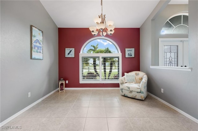 living area with light tile patterned flooring and an inviting chandelier