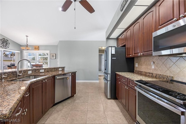 kitchen featuring light tile patterned flooring, sink, dark stone countertops, decorative backsplash, and stainless steel appliances