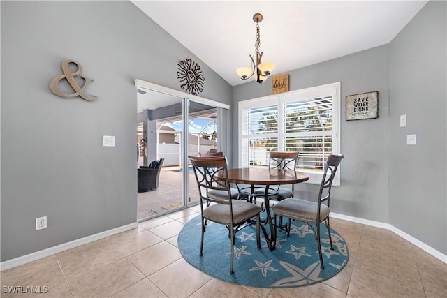 tiled dining room with lofted ceiling and a chandelier