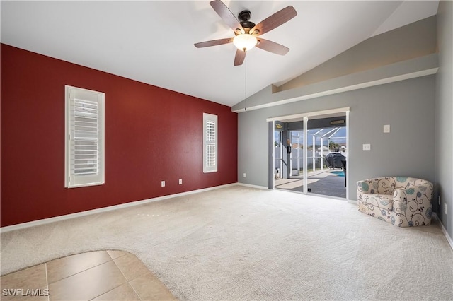 unfurnished room with lofted ceiling, ceiling fan, and carpet