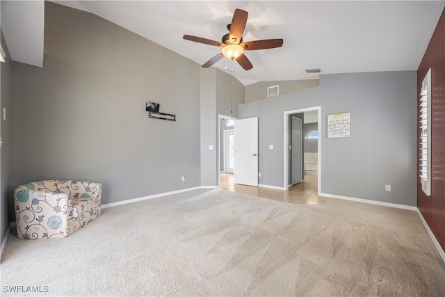 unfurnished bedroom featuring high vaulted ceiling, light colored carpet, and ceiling fan