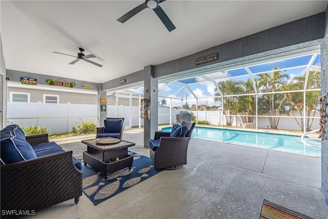 view of patio with outdoor lounge area, ceiling fan, a lanai, and a fenced in pool