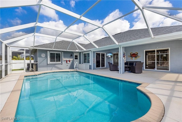 view of pool with a patio and glass enclosure