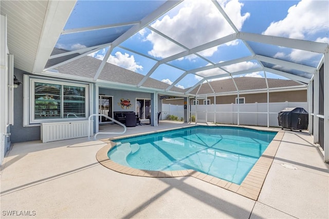 view of swimming pool with grilling area, a lanai, and a patio