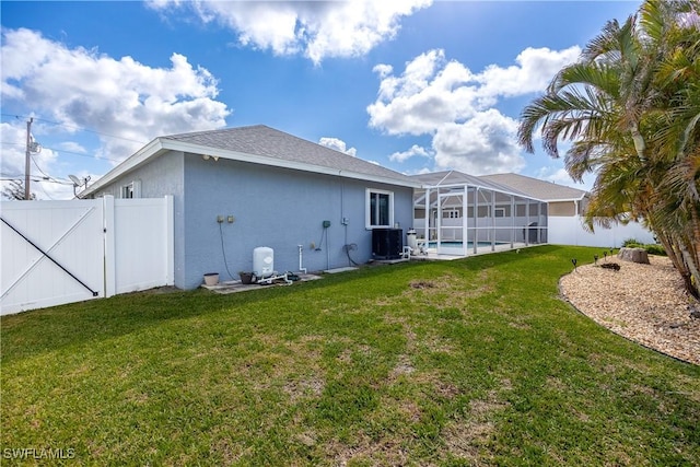 back of house with central AC, a yard, a fenced in pool, and glass enclosure