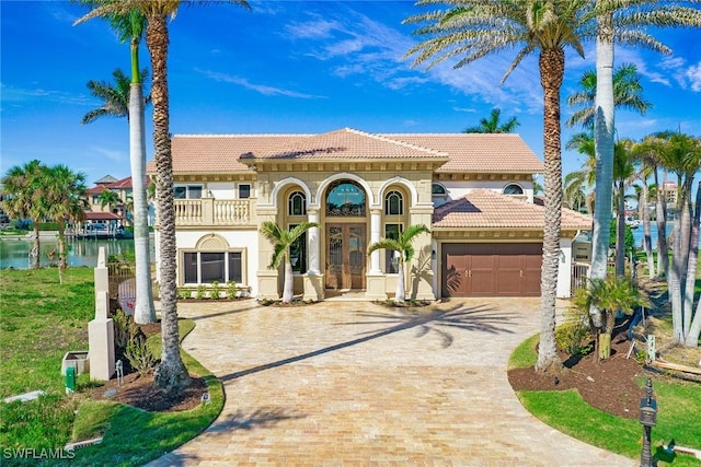 342 Germain Ave, Naples, FL 34108 - mediterranean / spanish home featuring stucco siding, a tile roof, driveway, a balcony, and an attached garage