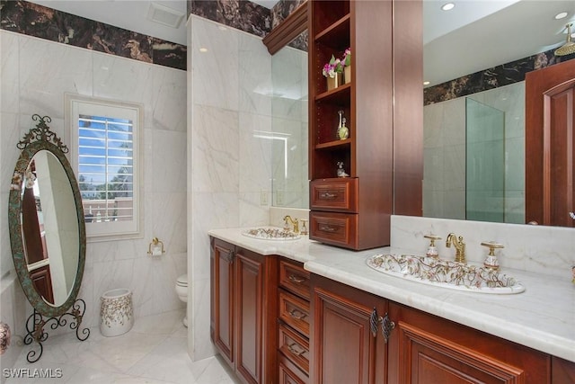 342 Germain Ave, Naples, FL 34108 - bathroom featuring a sink, double vanity, toilet, tile walls, and marble finish floor