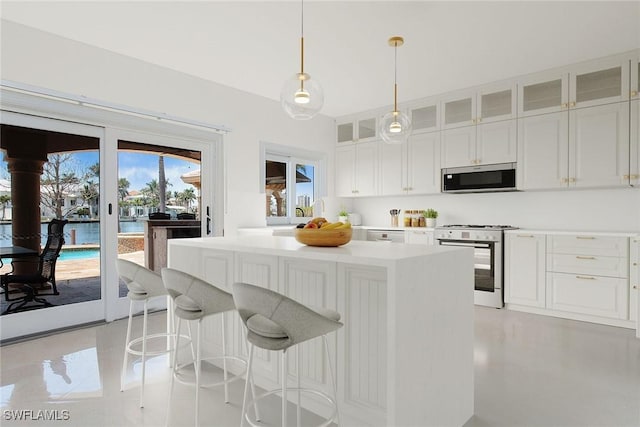 342 Germain Ave, Naples, FL 34108 - kitchen with white cabinetry, glass insert cabinets, stainless steel appliances, a kitchen island, and light countertops