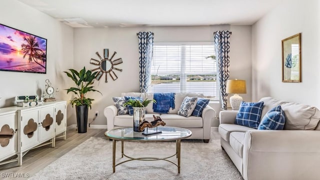 living area with light wood-style floors and baseboards