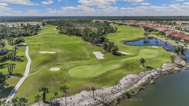 birds eye view of property with a water view and golf course view