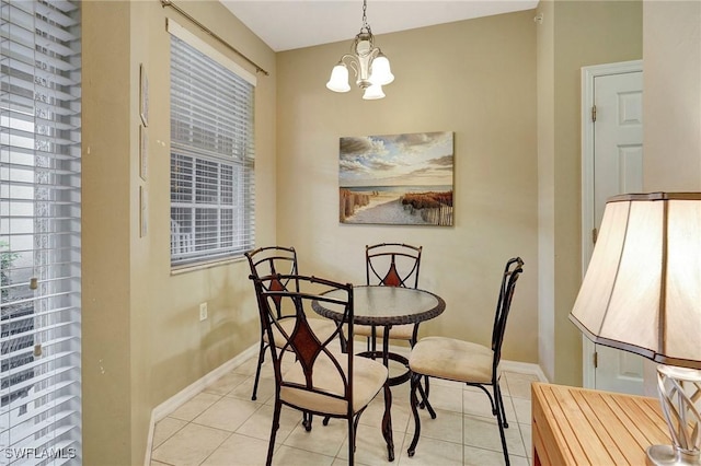 dining area featuring light tile patterned floors and a notable chandelier