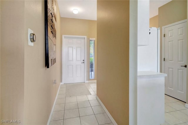 hall featuring light tile patterned floors