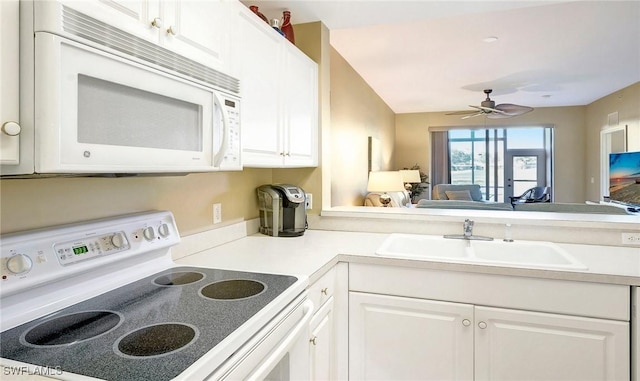 kitchen with white cabinetry, sink, and white appliances